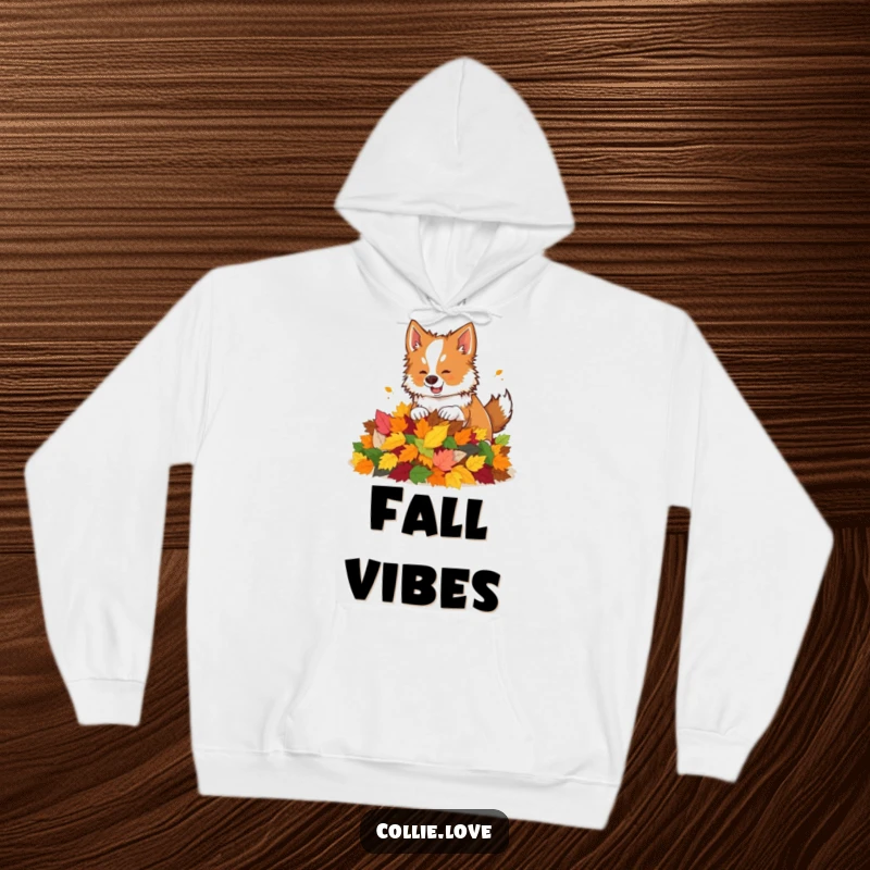 Funny hoodie depicting a Collie dog playfully interacting with a pile of colorful autumn leaves.