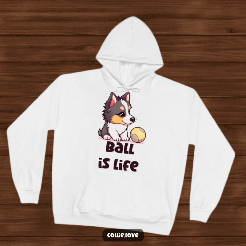 Funny Collie puppy hoodie, head tilted, eyes locked on a bouncing ball, showcasing a hilarious, concentrated dog expression, great funny gift.