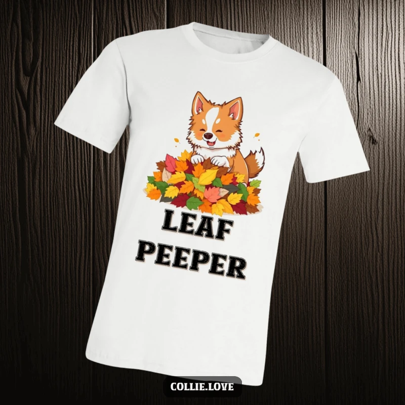 Funny t-shirt graphic of a happy Collie dog playfully nudging a large pile of colorful autumn leaves.