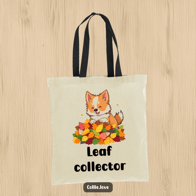 Funny tote bag featuring a Collie dog curiously nudging a pile of colorful autumn leaves.